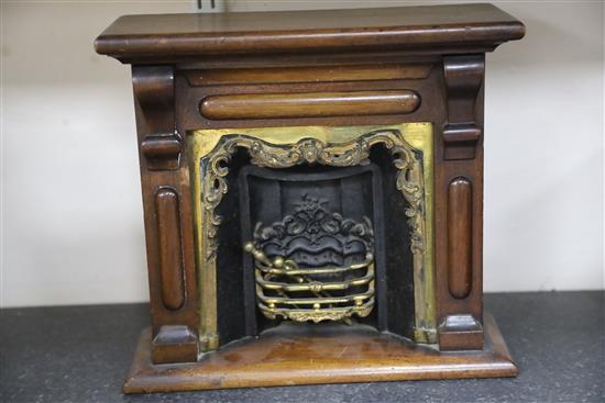 A late Victorian mahogany miniature fireplace, 11.5in. height 10.75in., with associated wirework fire guard